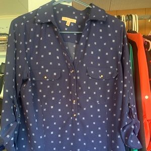 Navy blue and white patterned blouse.